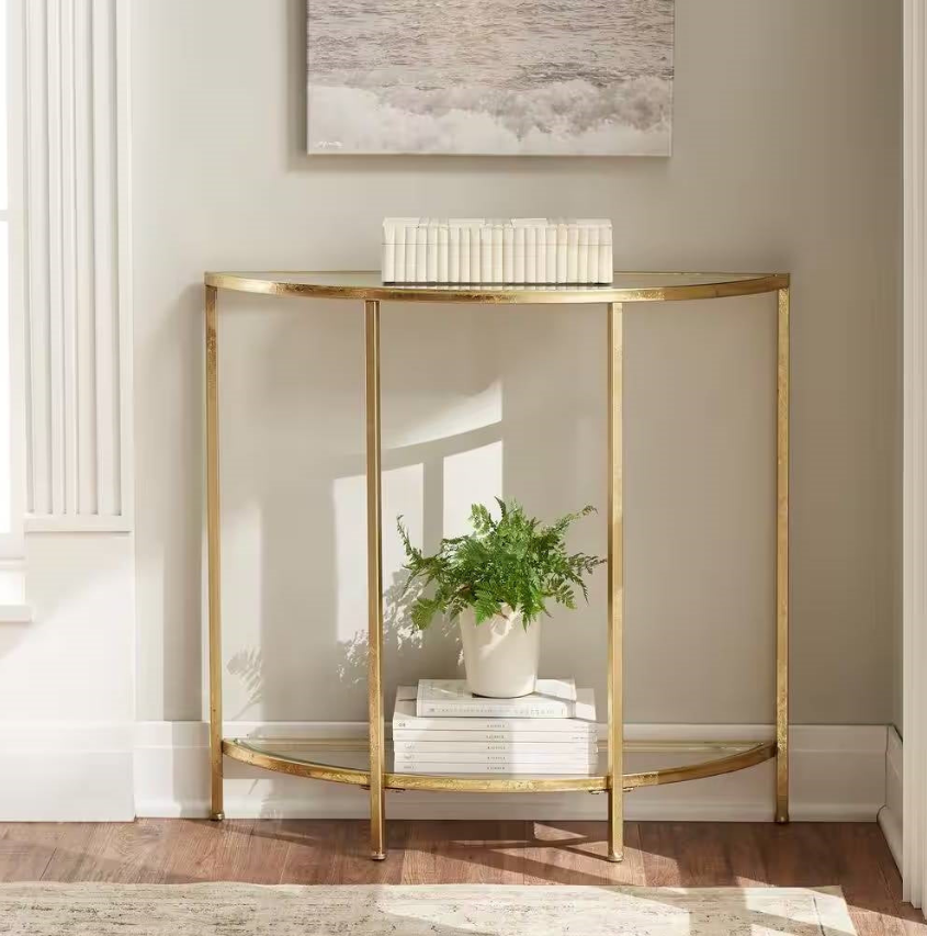 Classic Foyer elegant gold console table with a plant and stacked books, enhancing stylish entrance decor.