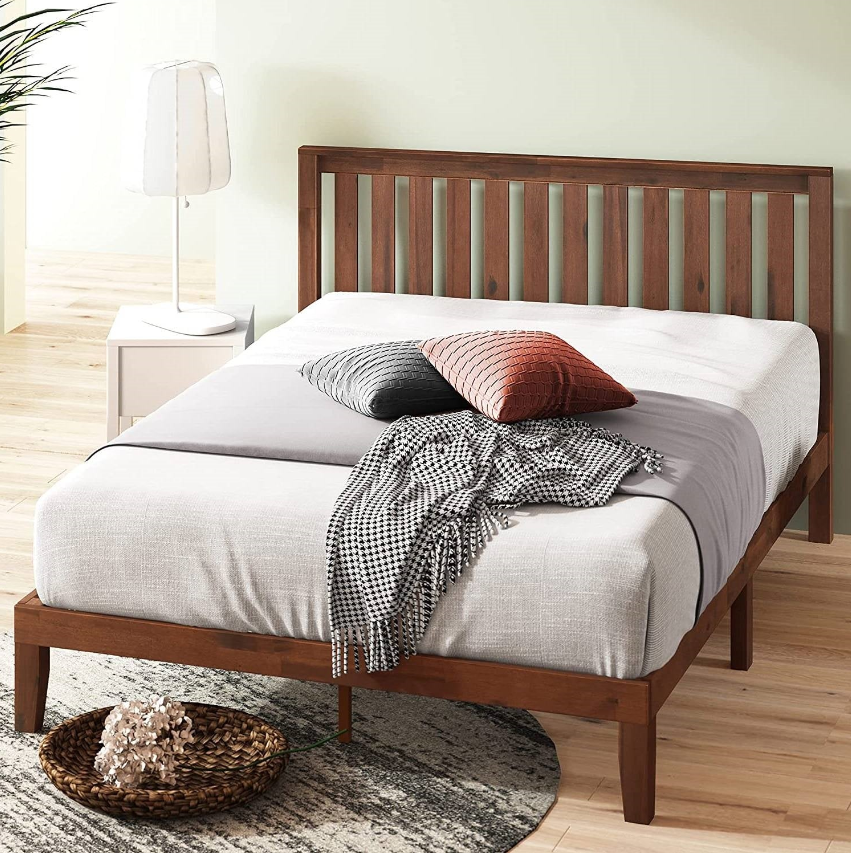 A stylish Mission Bedroom featuring a wooden bed frame with neutral bedding and decorative pillows.