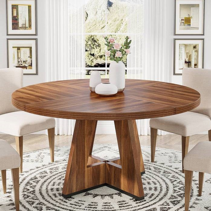 Farmhouse Dining Room featuring a round wooden table with stylish chairs in a bright, welcoming space.