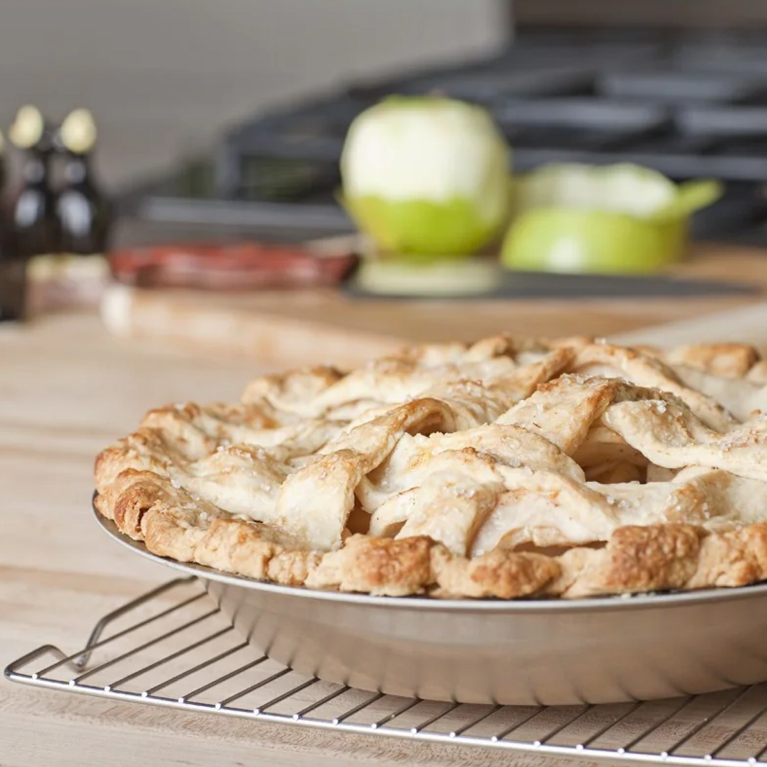 Freshly baked pie in a pie pan cooling on a rack, perfect for delicious desserts using pie pans.