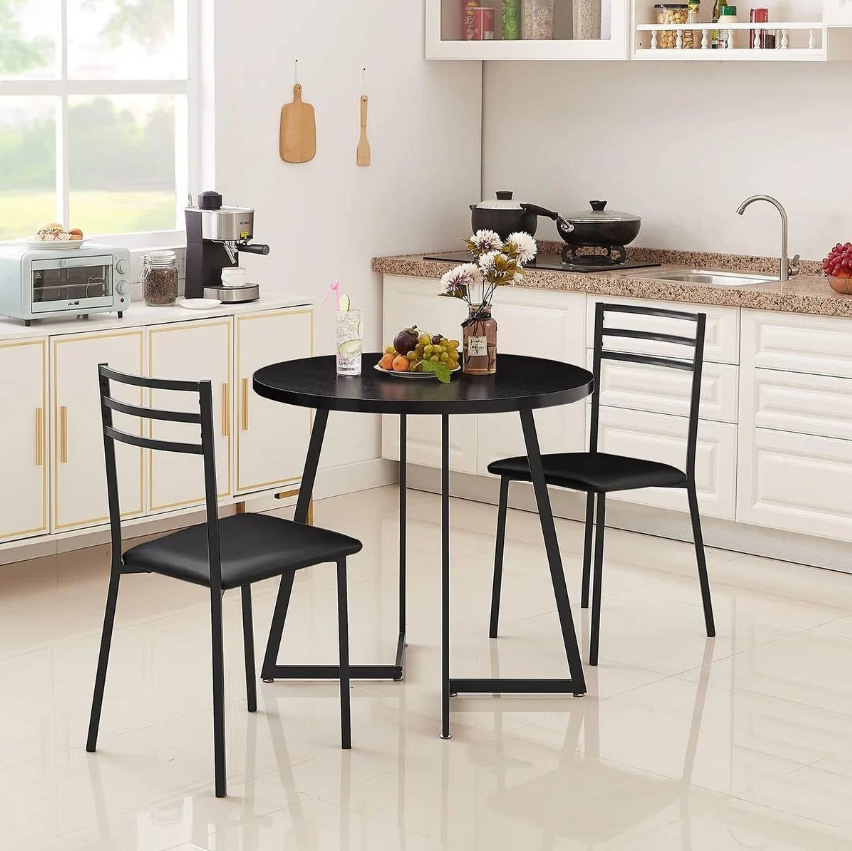 Modern Kitchen featuring a black round table and two chairs with a floral centerpiece.