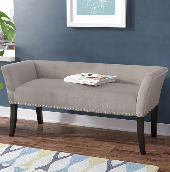 Mid-Century Modern Foyer featuring a stylish gray bench with nailhead trim and wooden legs.