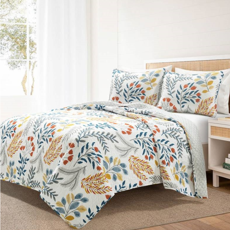 Scandinavian Kids' Bedroom featuring a floral quilt and matching pillows on a bed in a bright, cozy room.