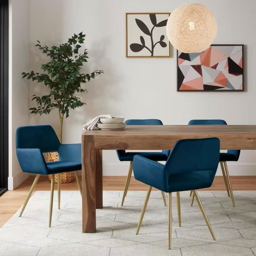 Scandinavian Dining Room featuring a wooden table, stylish blue chairs, and modern decor elements.