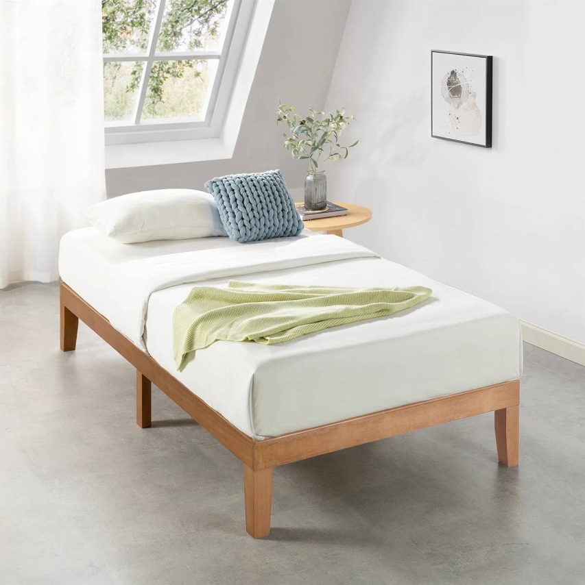 Mid-Century Modern Kids' Bedroom featuring a minimalist bed with fresh bedding and decorative pillows.