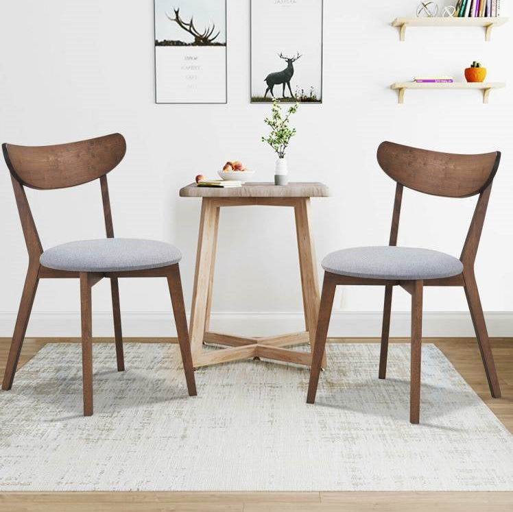 Mid-Century Modern Kitchen featuring stylish wooden chairs and a round table in a cozy setting.