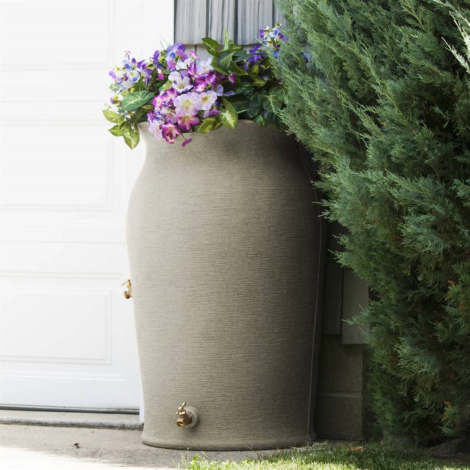 Gardening Equipment stylish rain barrel planter with colorful flowers in a garden setting.