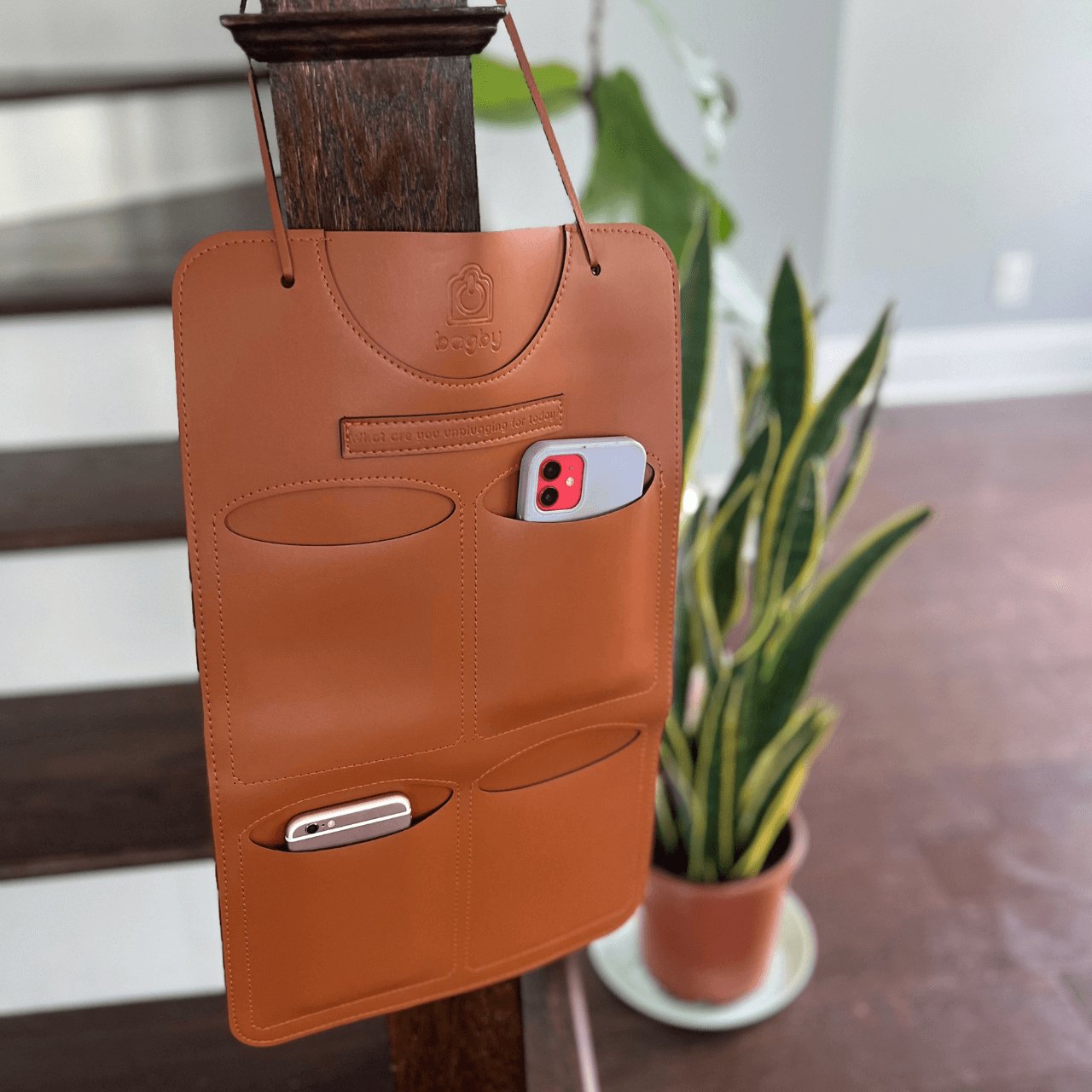 Stylish Phone Holders mounted on a wooden post, designed to organize smartphones and accessories.