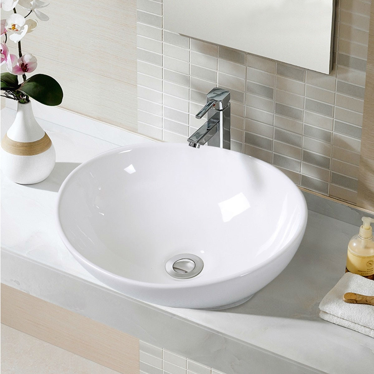 Modern white bathroom sink with sleek faucet and elegant countertop decor.