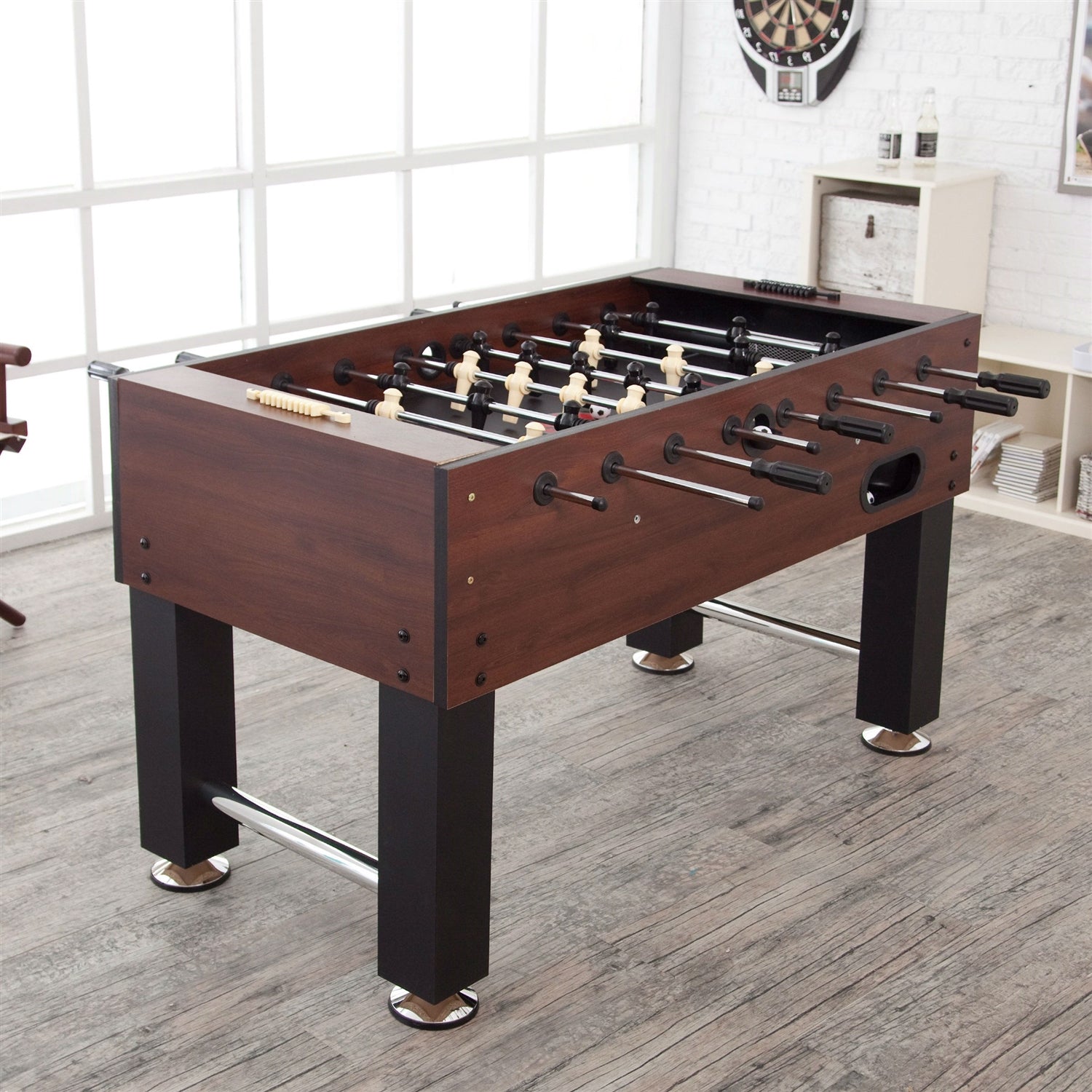 A sturdy foosball table in a modern game room setting featuring black and brown design.