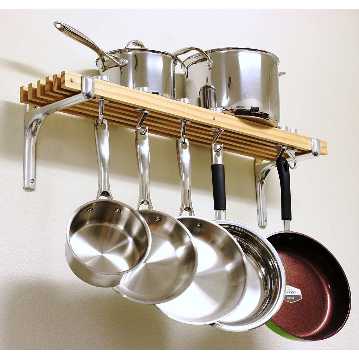 Stylish wooden pot rack displaying pots and pans organized for easy access in a kitchen setting. Pot Racks.