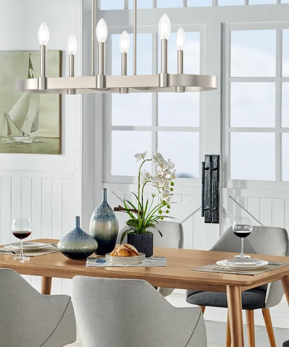 Coastal Dining Room featuring a stylish chandelier over a modern wooden table with elegant decor and natural light.