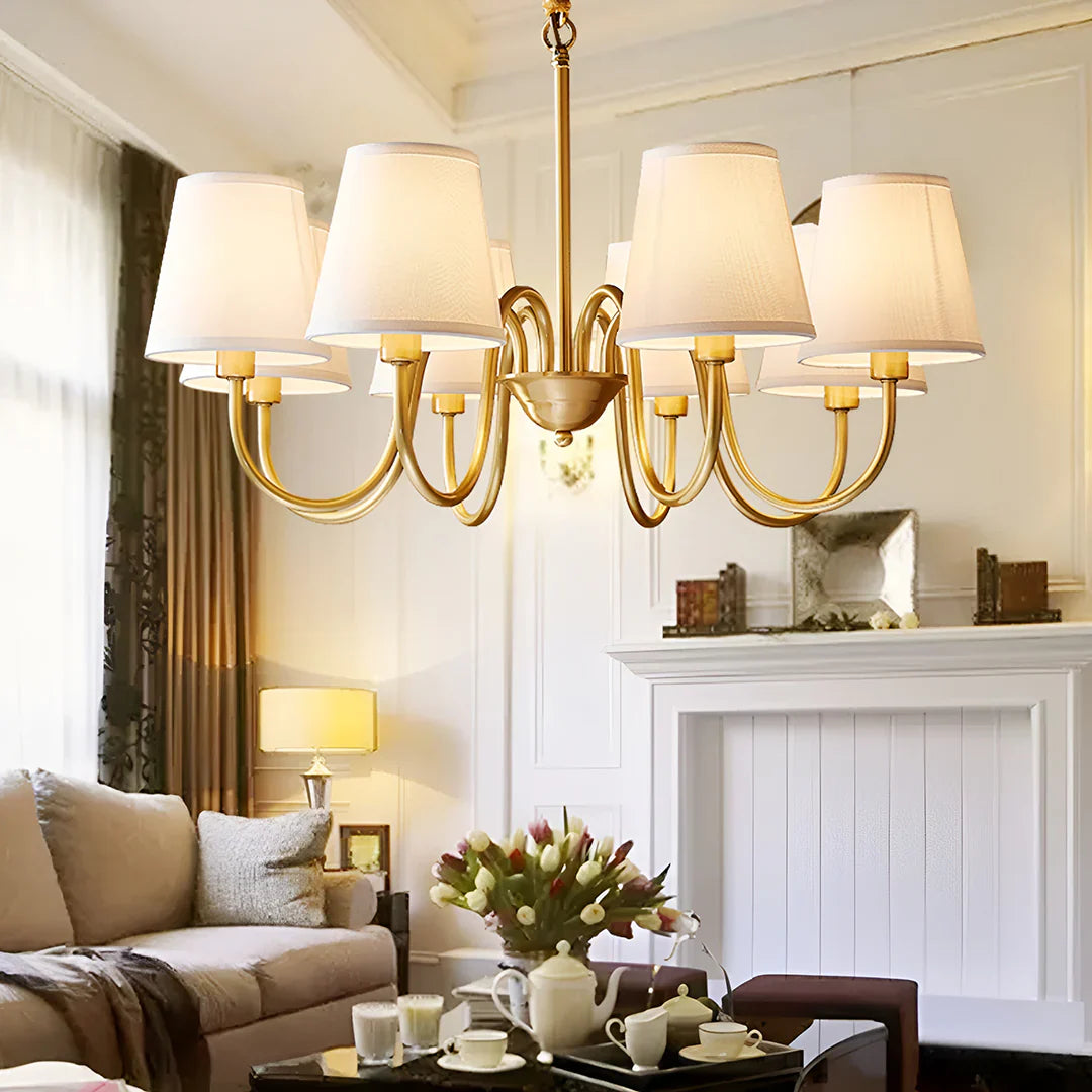 Elegant gold chandelier with fabric lampshades, illuminating a stylish living room. Focus on Chandeliers.