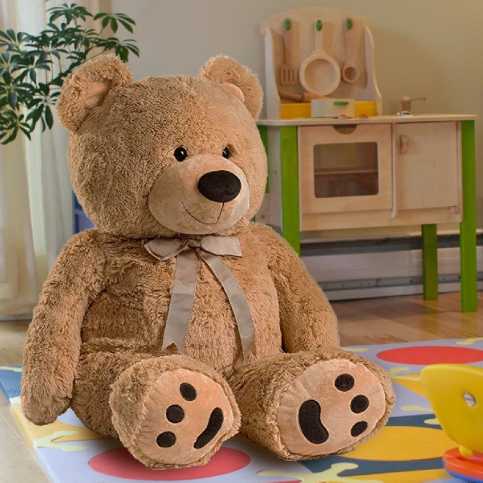 Stuffed Animals and Dolls collection featuring a cute brown teddy bear with a ribbon.