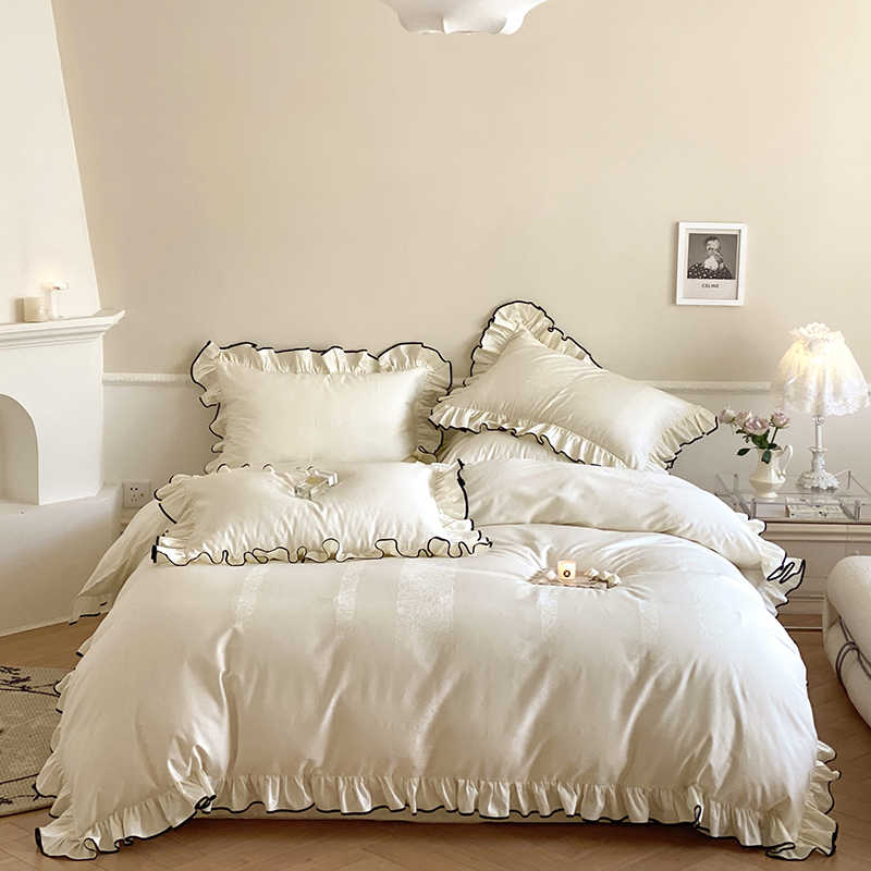 Elegant bedding collection featuring Full and Queen Duvets with ruffled edges and plush pillows.