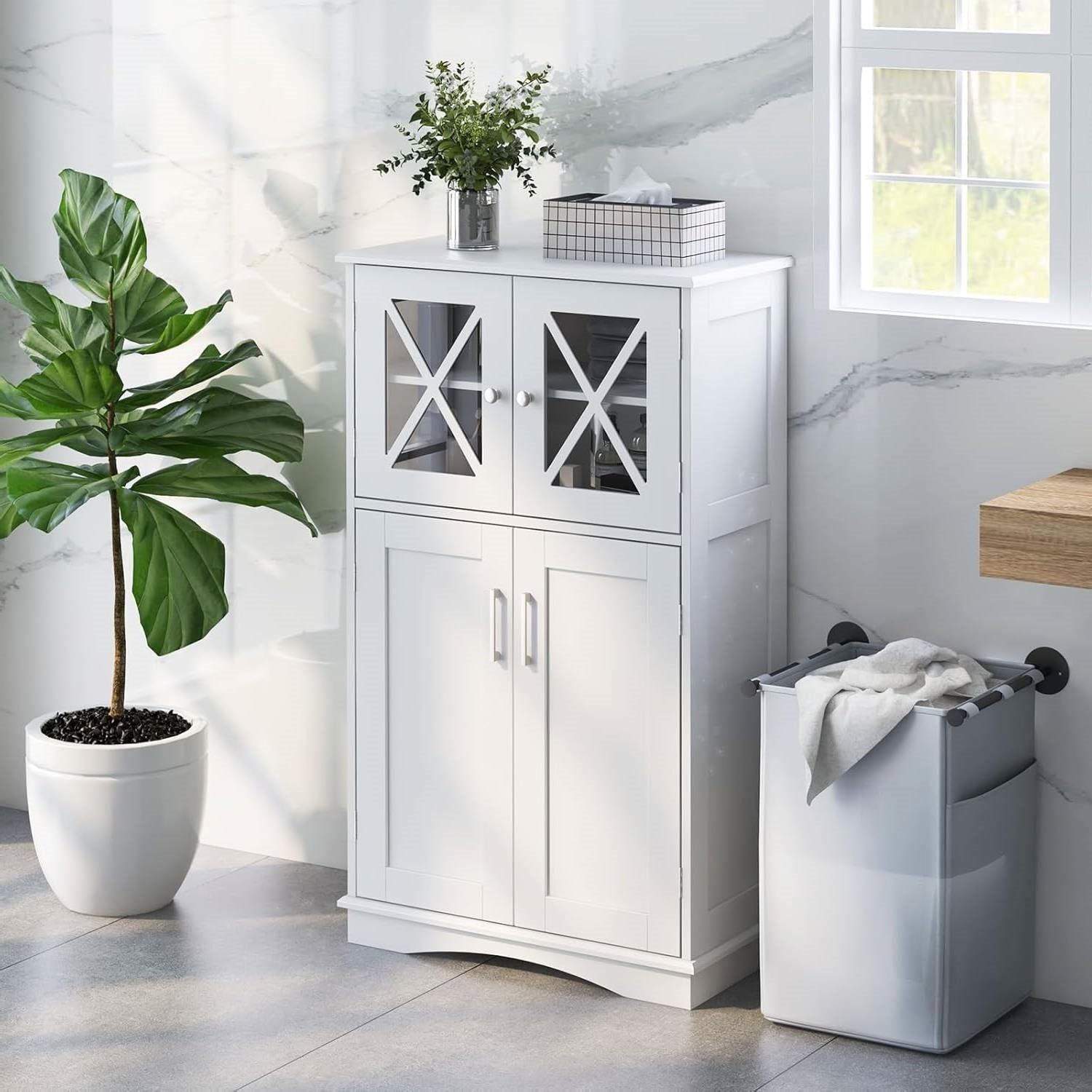 Modern white linen cabinet with glass doors in a bright bathroom setting.