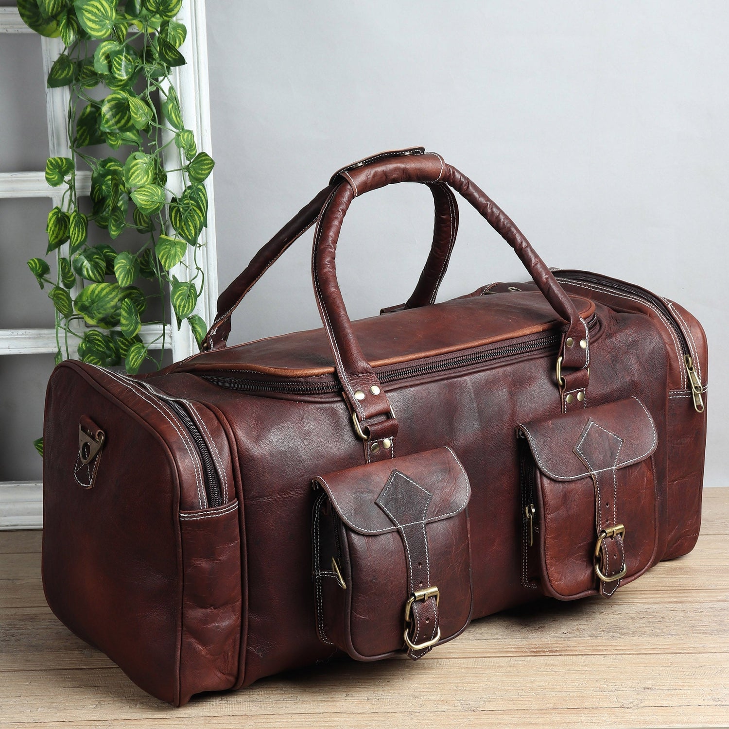 Luggage made of high-quality brown leather with multiple pockets for easy storage and travel convenience.