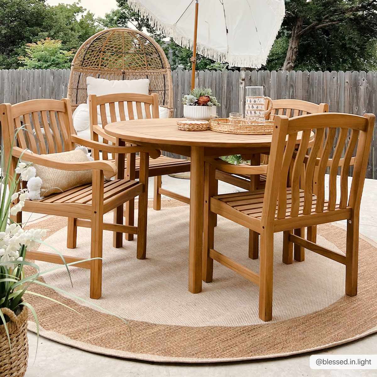 Patio Dining Sets featuring a wooden round table and matching chairs in an outdoor setting with a rug.