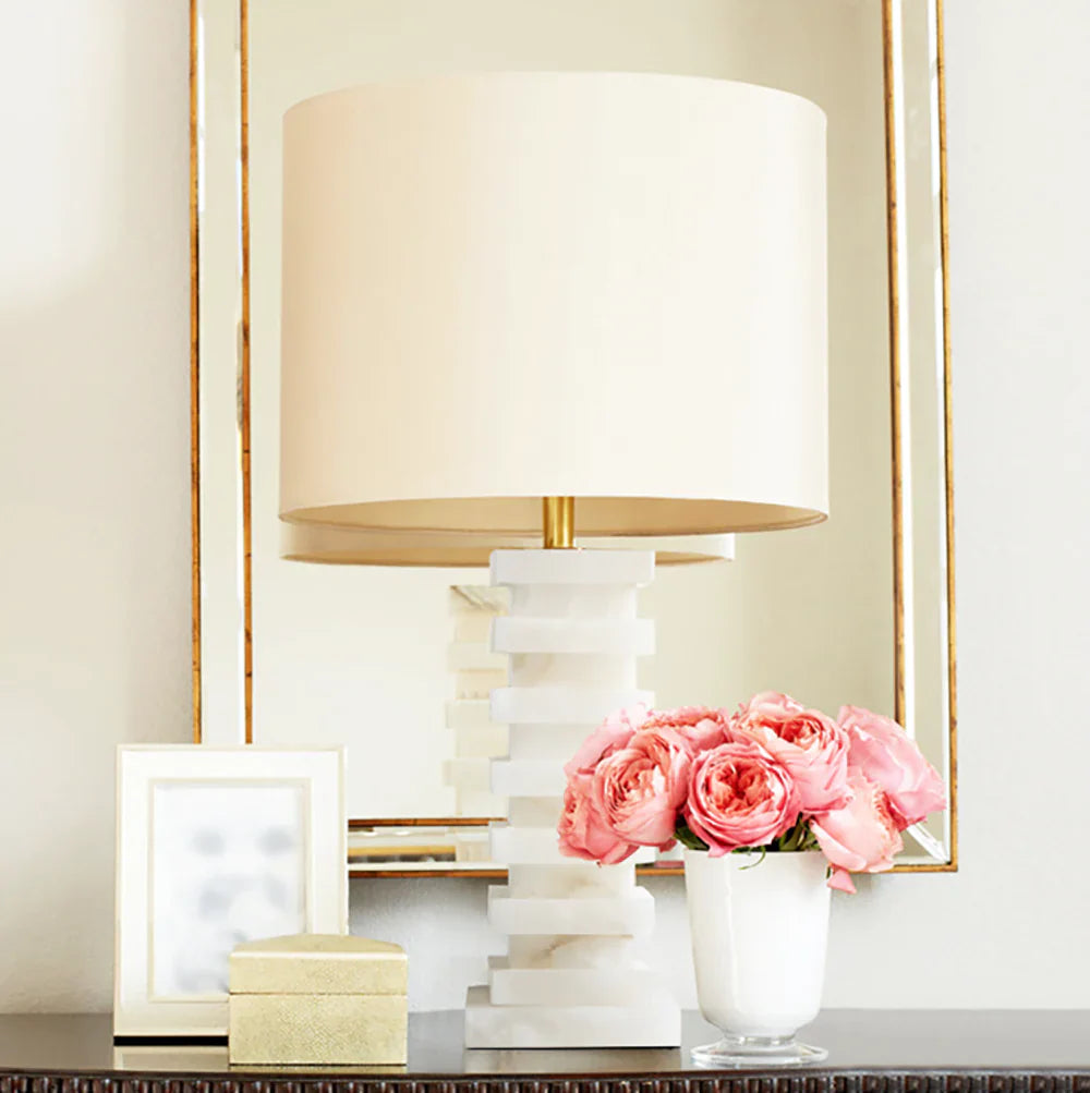 Elegant Table Lamps with beige shade, decorative vase of pink roses, and a mirror backdrop for a stylish room.