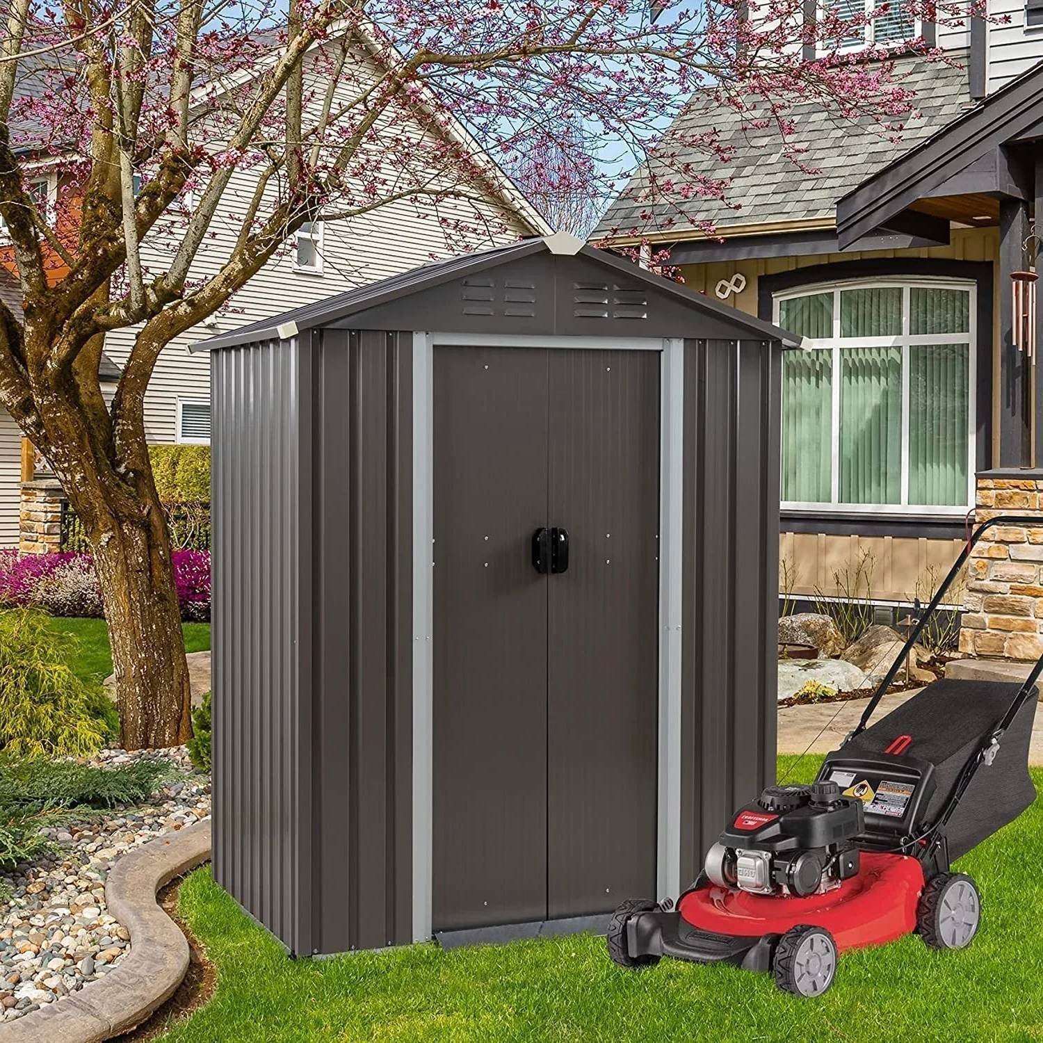 Lawn Mowers and garden shed in a landscaped yard, showcasing outdoor storage and lawn care equipment.