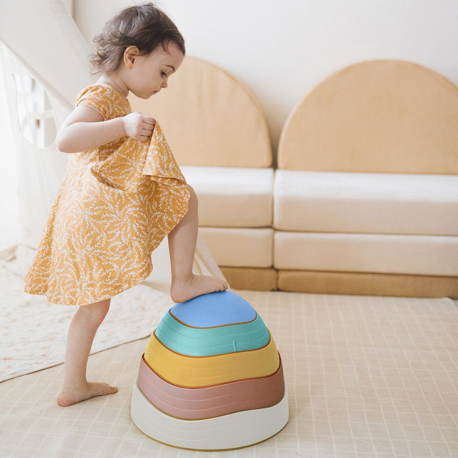 A child playing with colorful stacking toys from the Activity Toys collection.