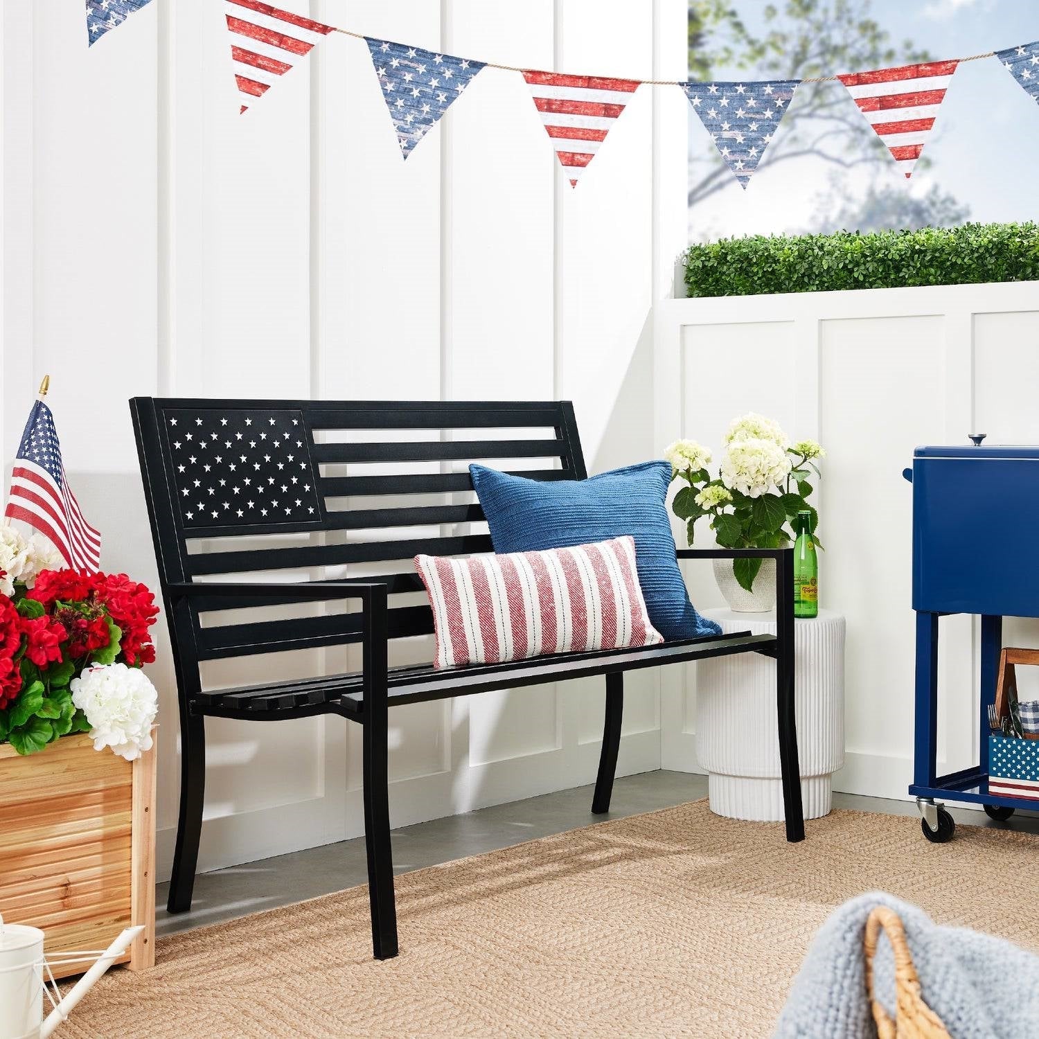 Patriotic Holiday Décor and Gifts featuring a bench with American flag decor and festive bunting.