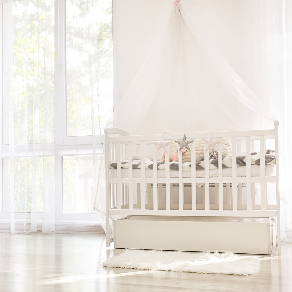 French Country Nursery with a white crib and soft drapes, creating a serene and charming atmosphere.