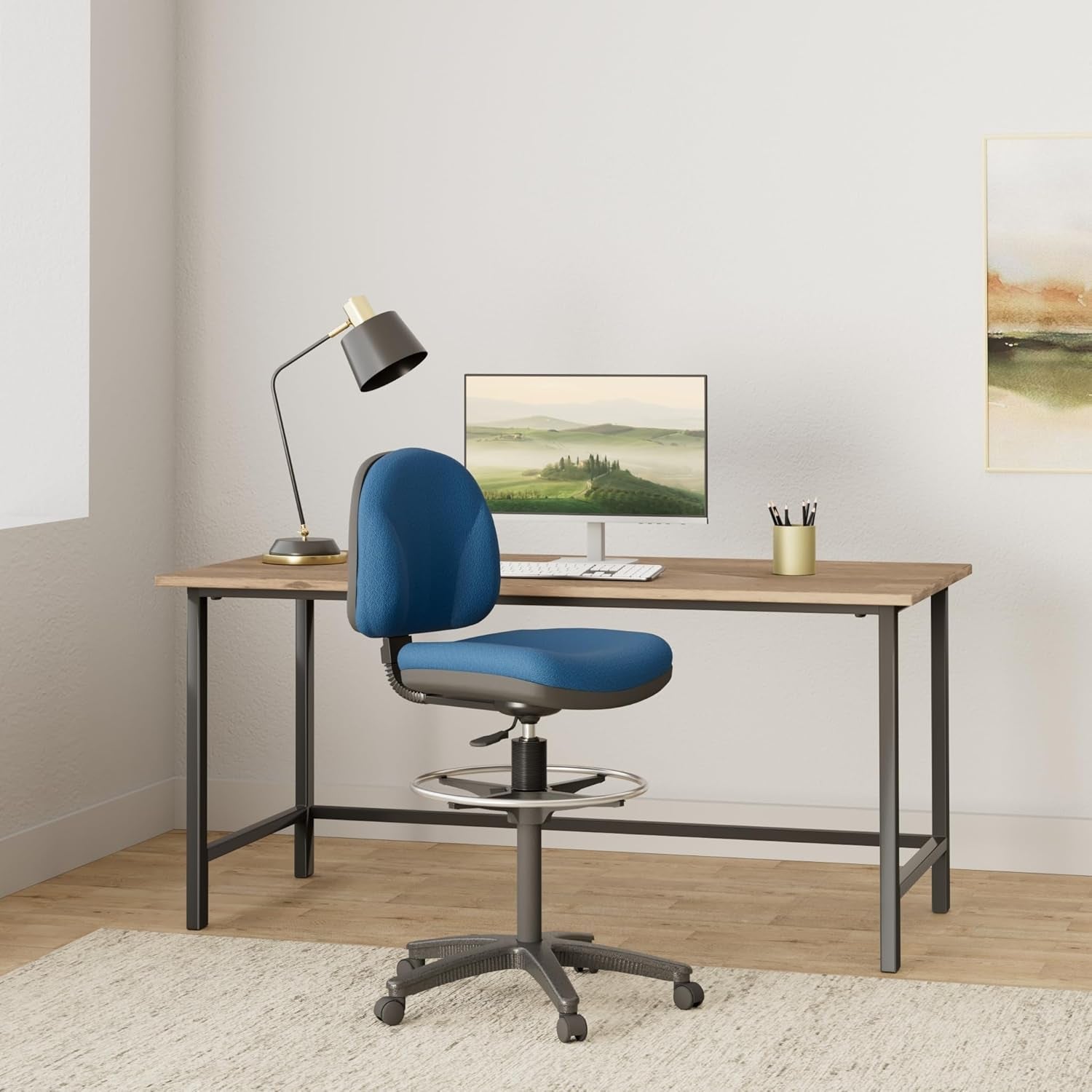 A stylish blue task chair at a minimalist desk setup with a lamp and monitor, perfect for home office use.
