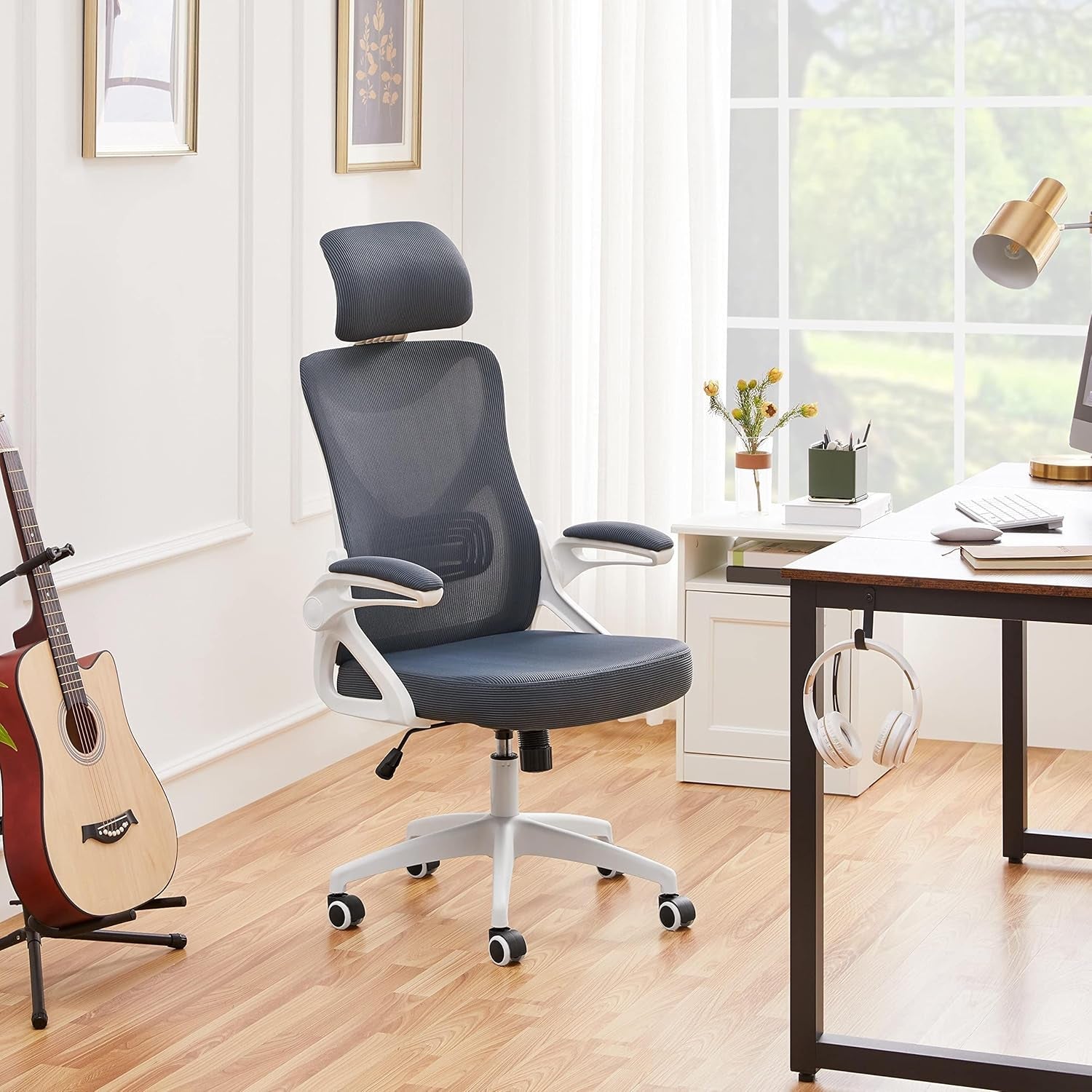 Ergonomic Office Chairs in a modern workspace with a guitar and headphones on the table.