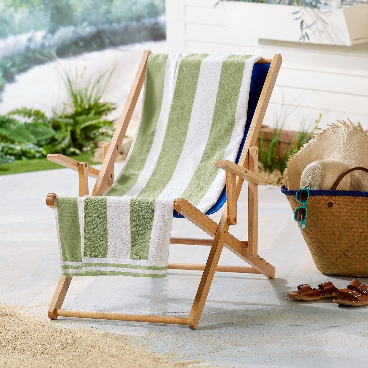 Beach Towels displayed on a wooden chair, featuring green and white stripes next to a beach bag and sandals.