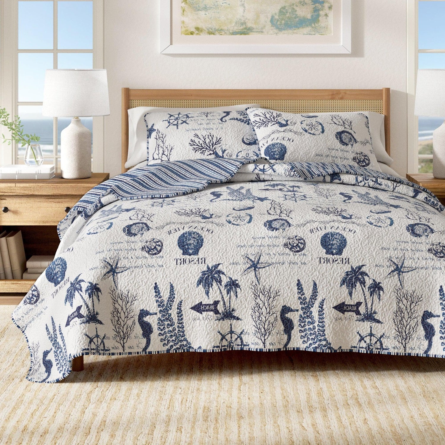 Coastal Bedroom featuring a nautical-themed quilt set with marine life patterns and a cozy atmosphere.