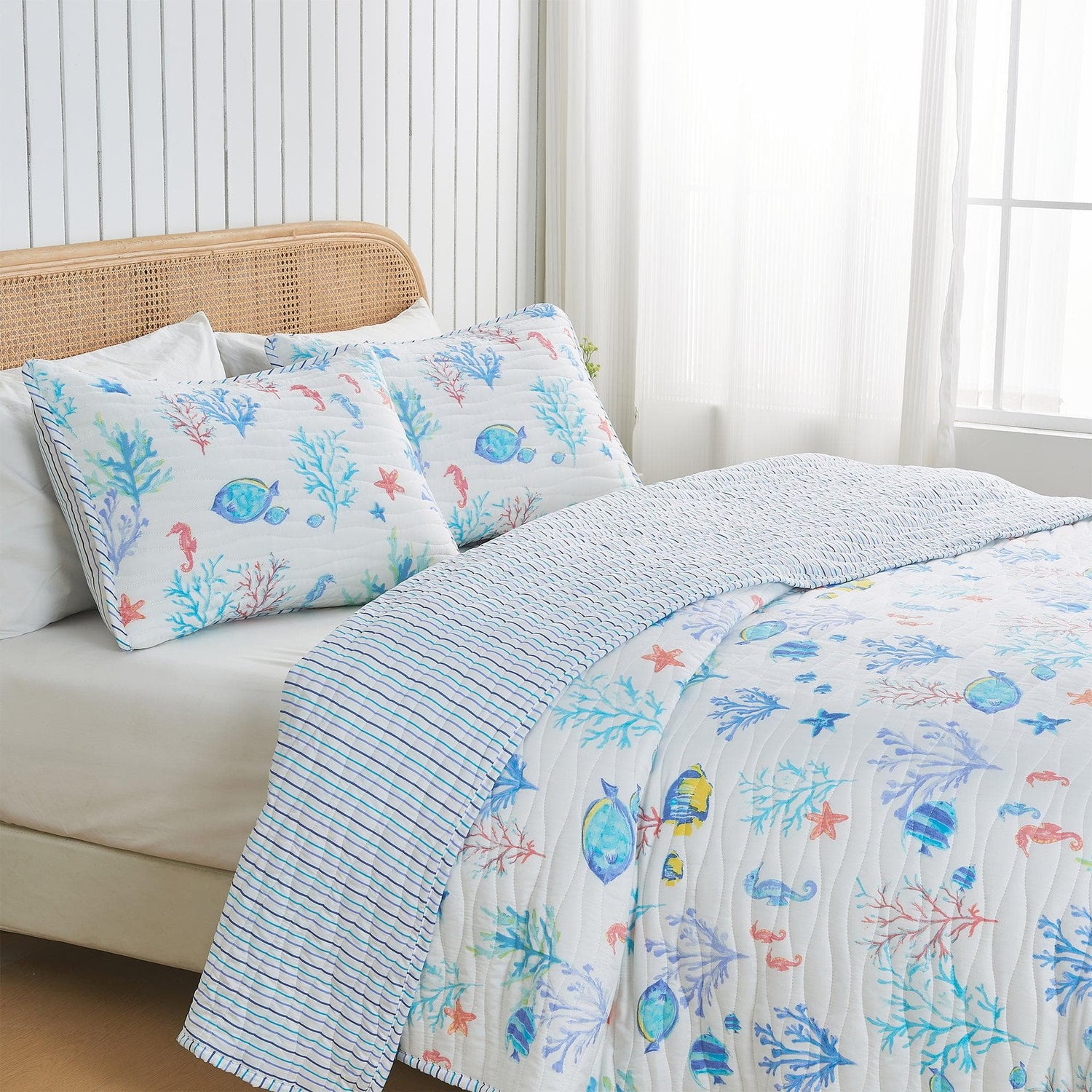 Coastal Kids' Bedroom featuring a watercolor marine-themed quilt and matching pillowcases on a bed.