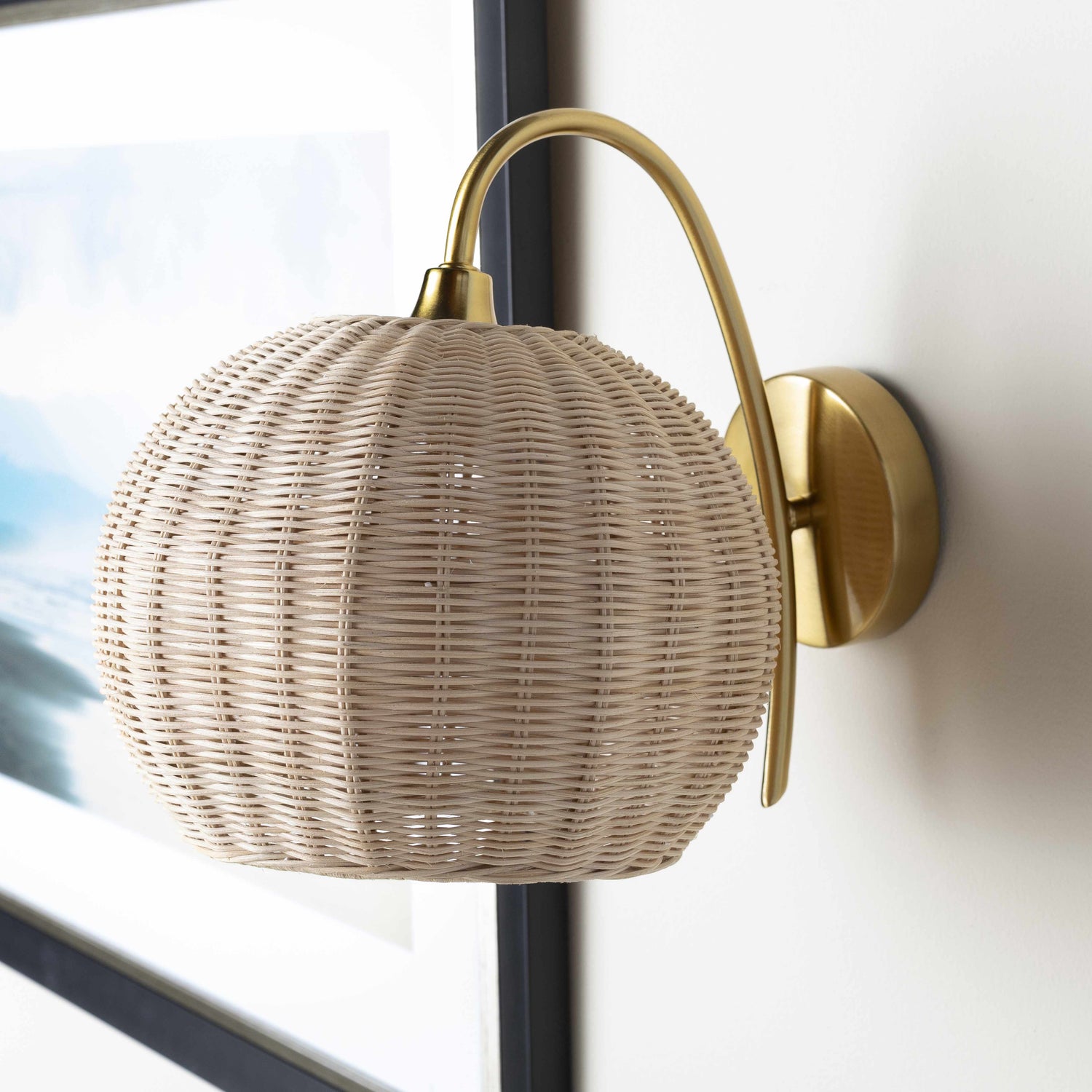 Elegant wall sconce with a woven design and gold accents, perfect for enhancing your decor with stylish wall sconces.