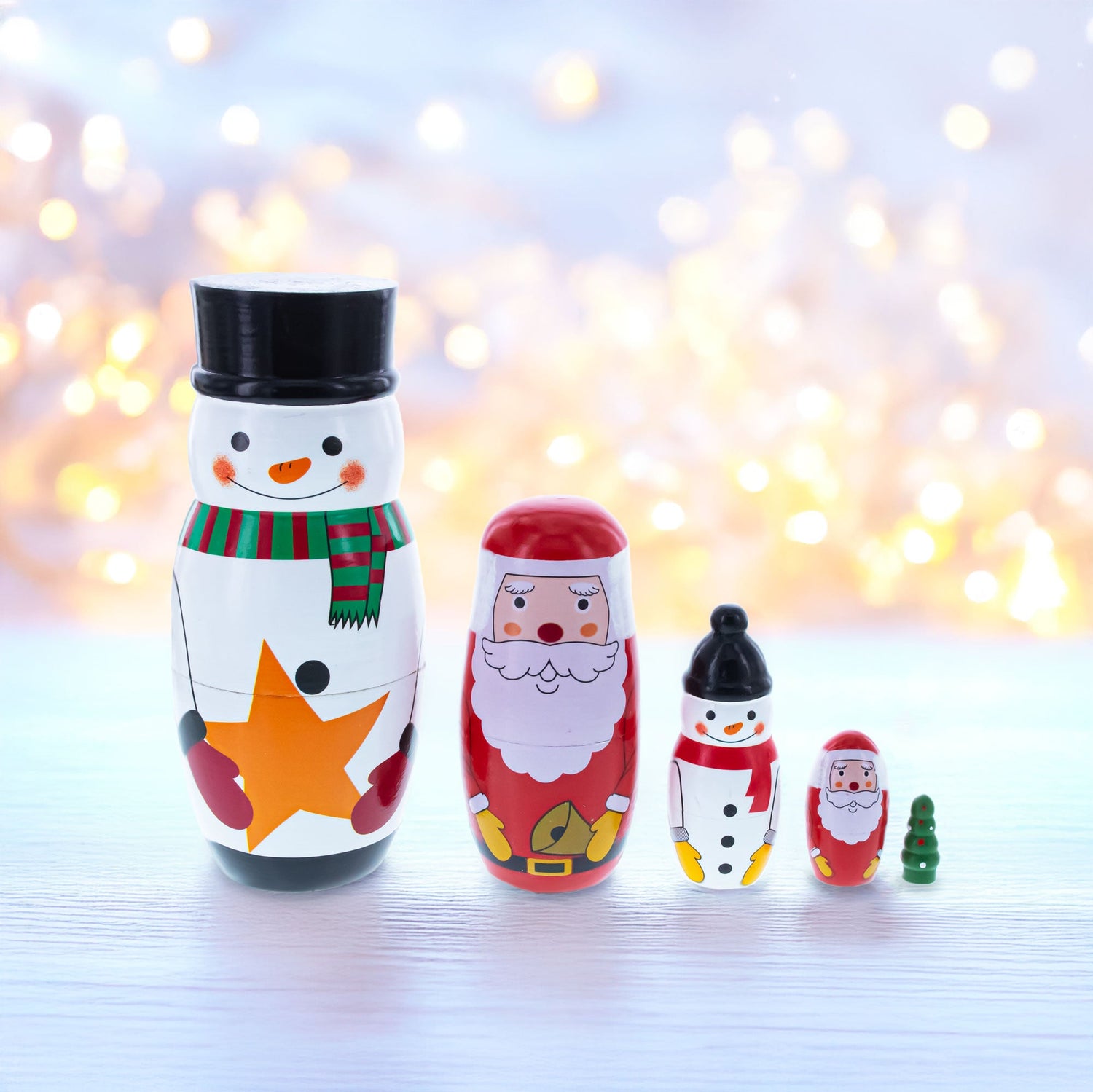 Nesting Dolls featuring a snowman, Santa, and festive figures against a blurred holiday backdrop.