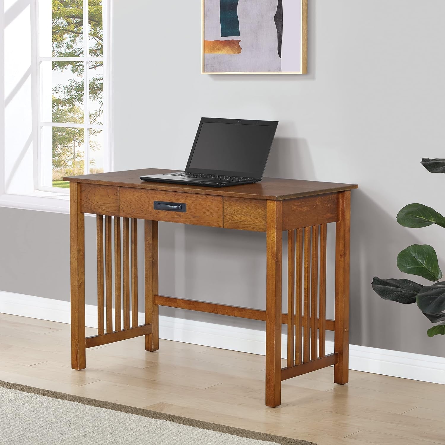 Stylish writing desks featuring a wooden structure with a laptop on top, ideal for home offices.