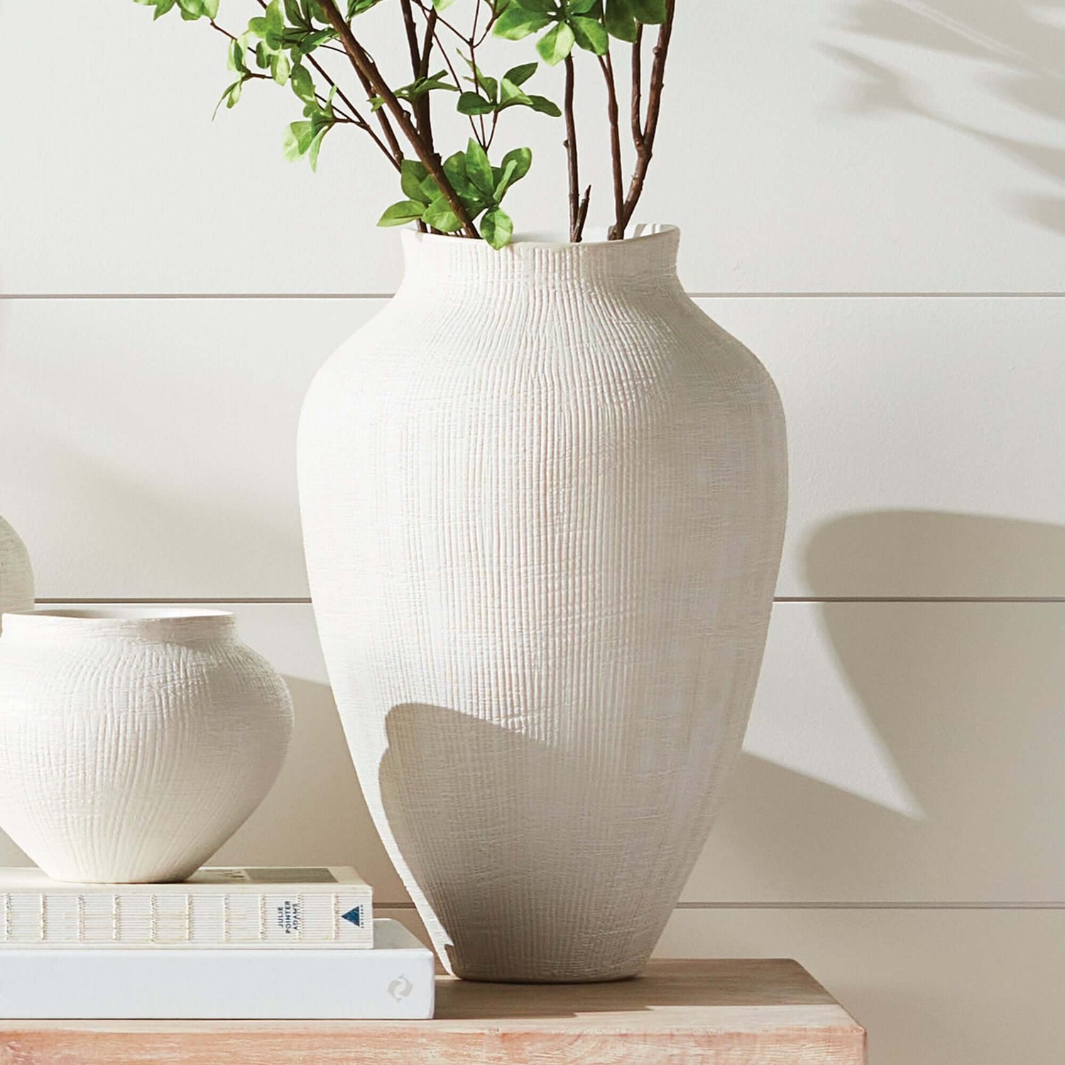 Elegant white vase with greenery, part of the stylish Vases collection.