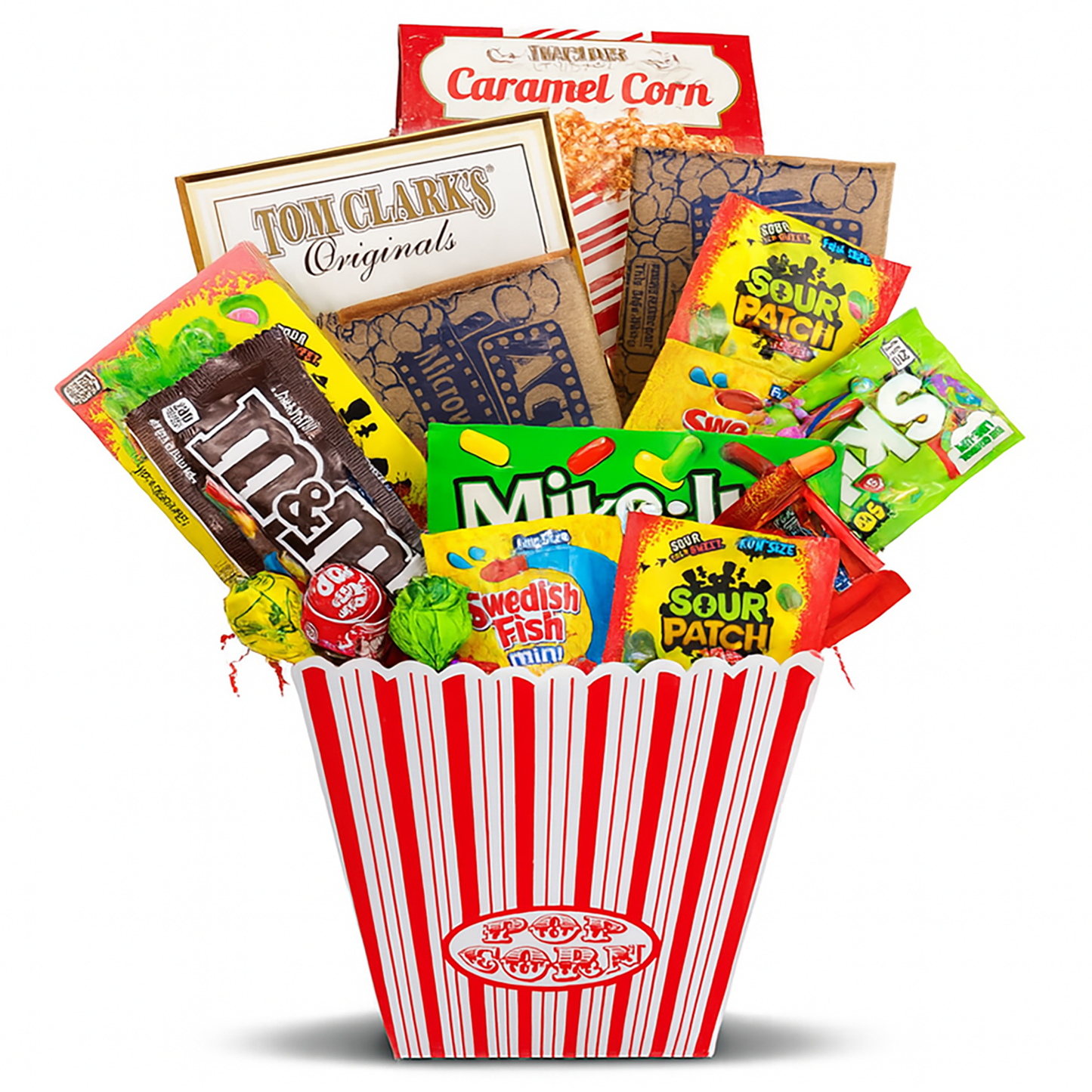 Assorted candy in a red and white striped basket on a white background