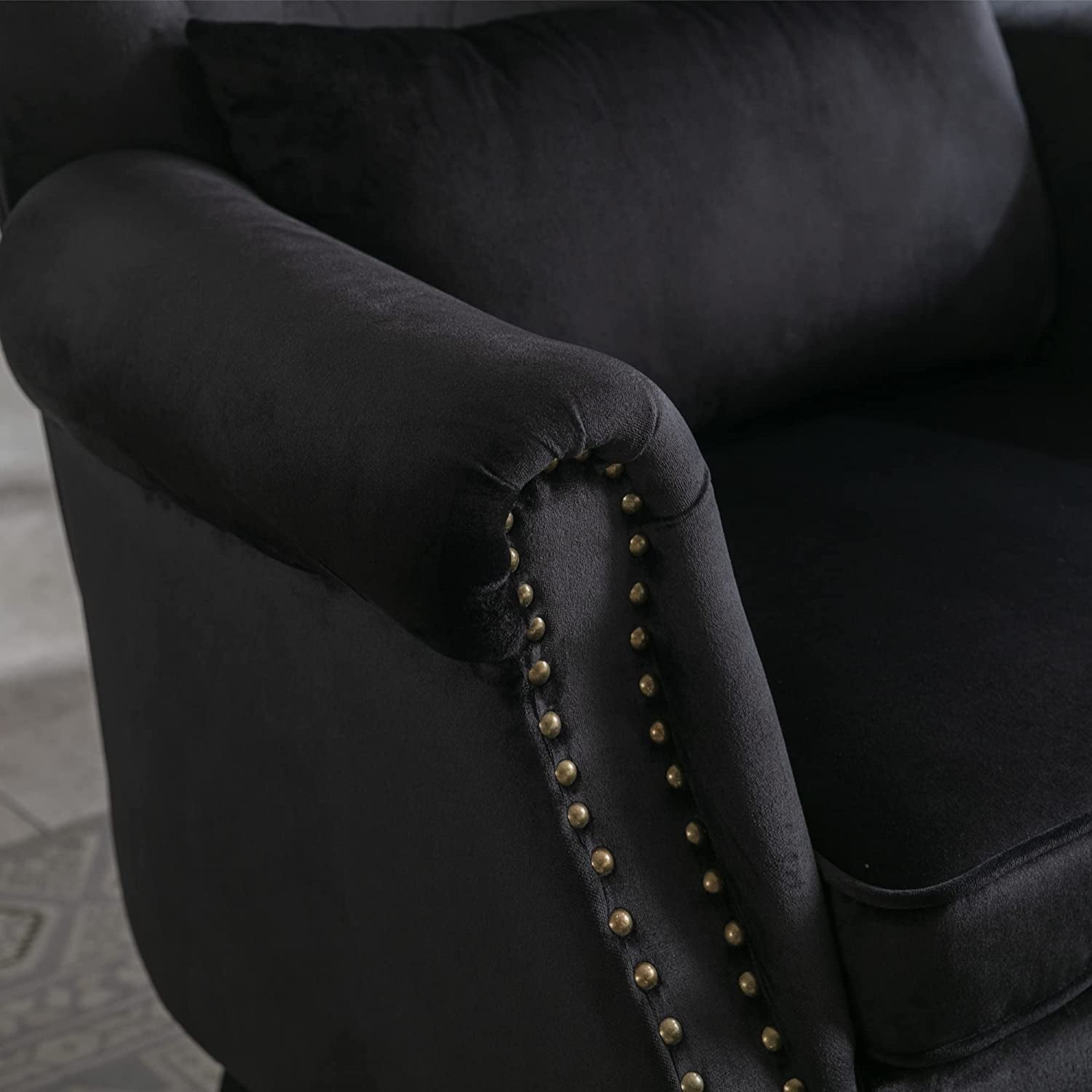 Elegant Black Velvet Wingback Chair With Ottoman Set showing detailed arm with gold nailhead trim.