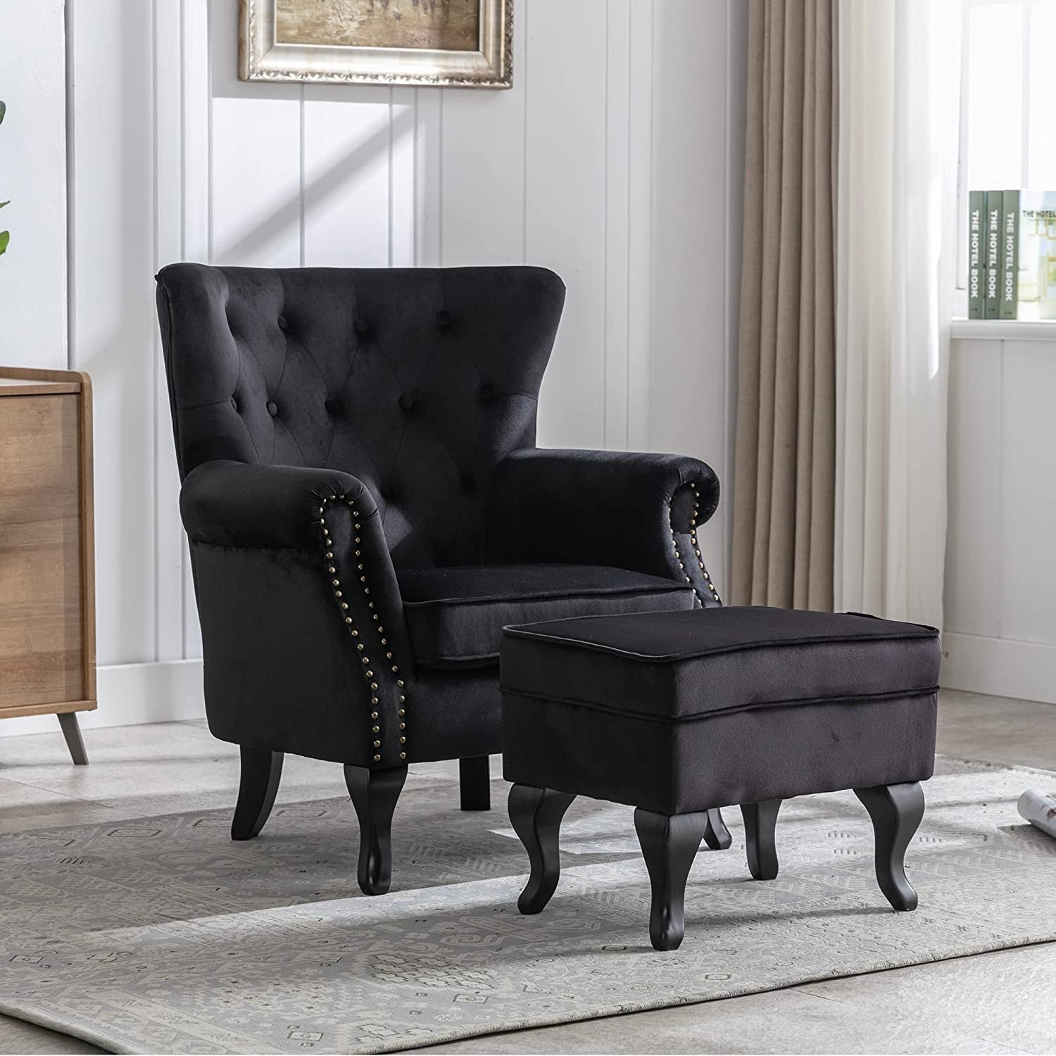 Elegant Black Velvet Wingback Chair With Ottoman Set in elegant living room.