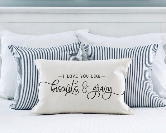 I Love You Like Biscuits and Gravy 12x20 inch Pillow Cover on a bed with striped pillows.
