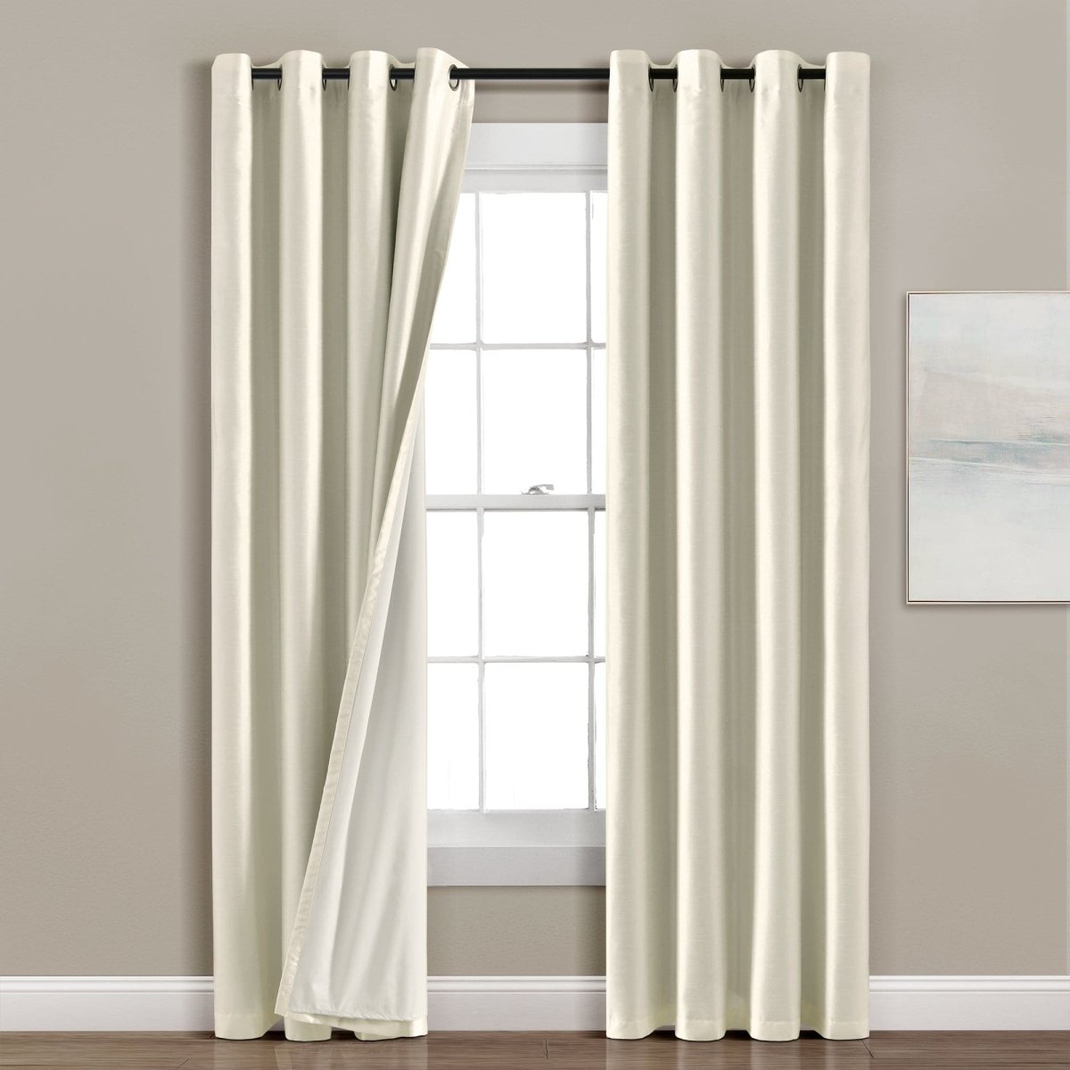 Faux Silk 100% Blackout Window Curtain panel hanging in a modern living room, providing complete privacy and elegant decor.