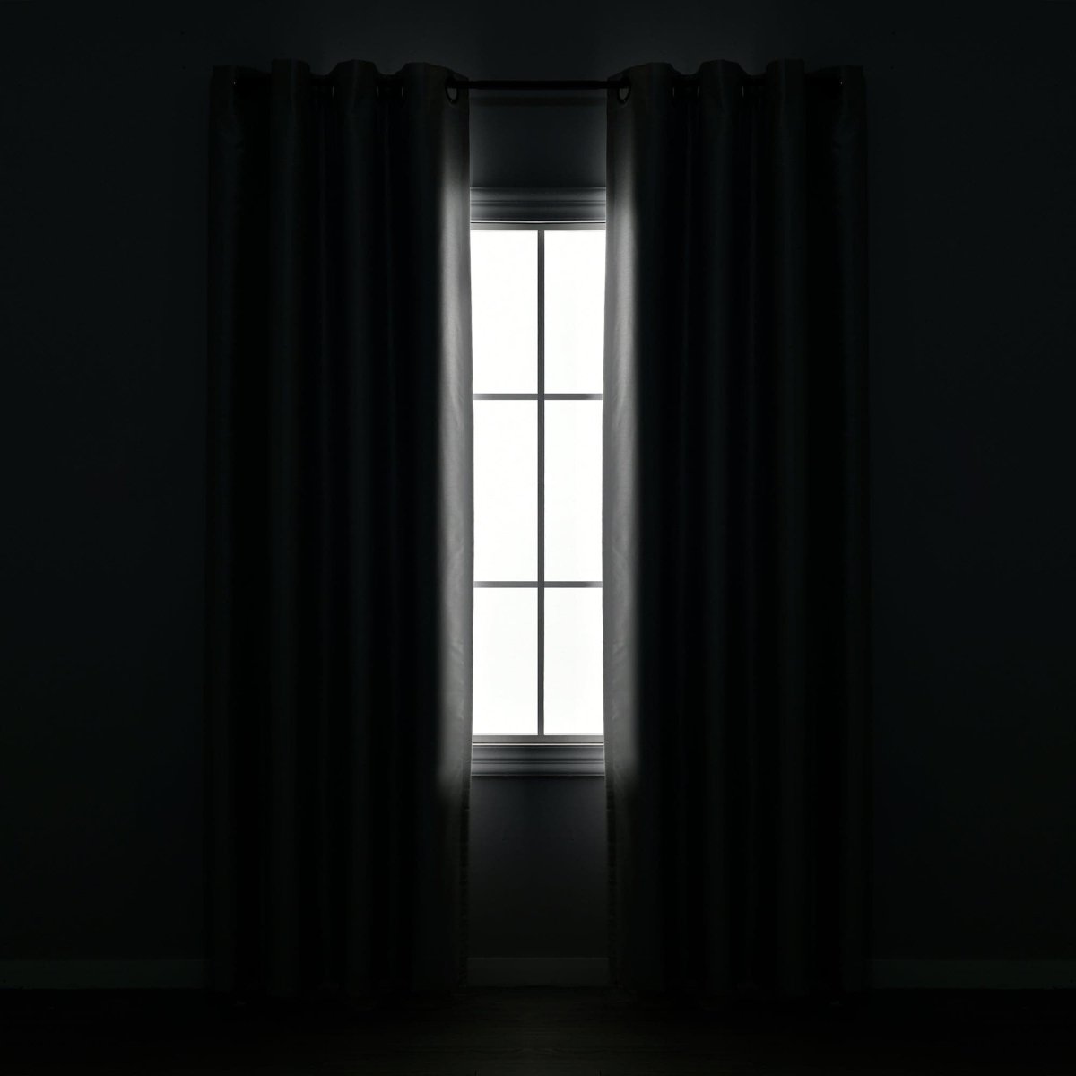Faux Silk 100% Blackout Window Curtain framing a bright window, enhancing privacy and luxury in any room.