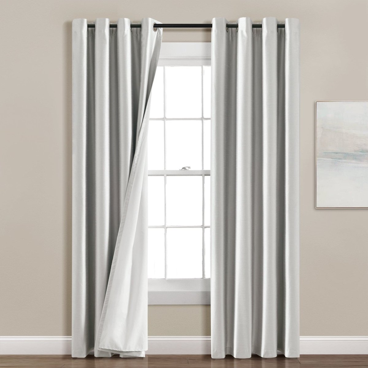 Faux Silk 100% Blackout Window Curtain panel hanging by a window, providing privacy and elegance.
