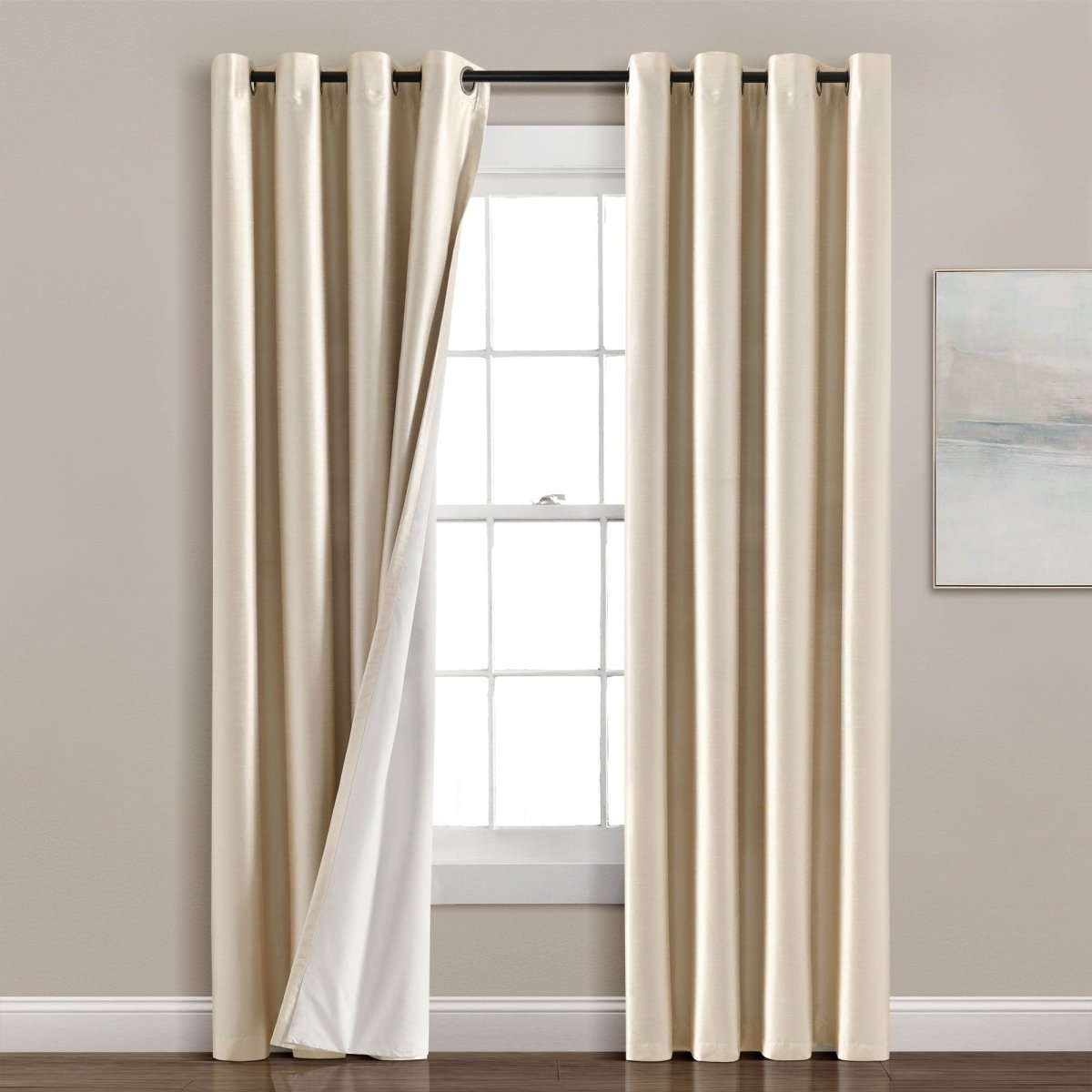 Faux Silk 100% Blackout Window Curtain hanging by a window, showcasing elegant design and true blackout feature.