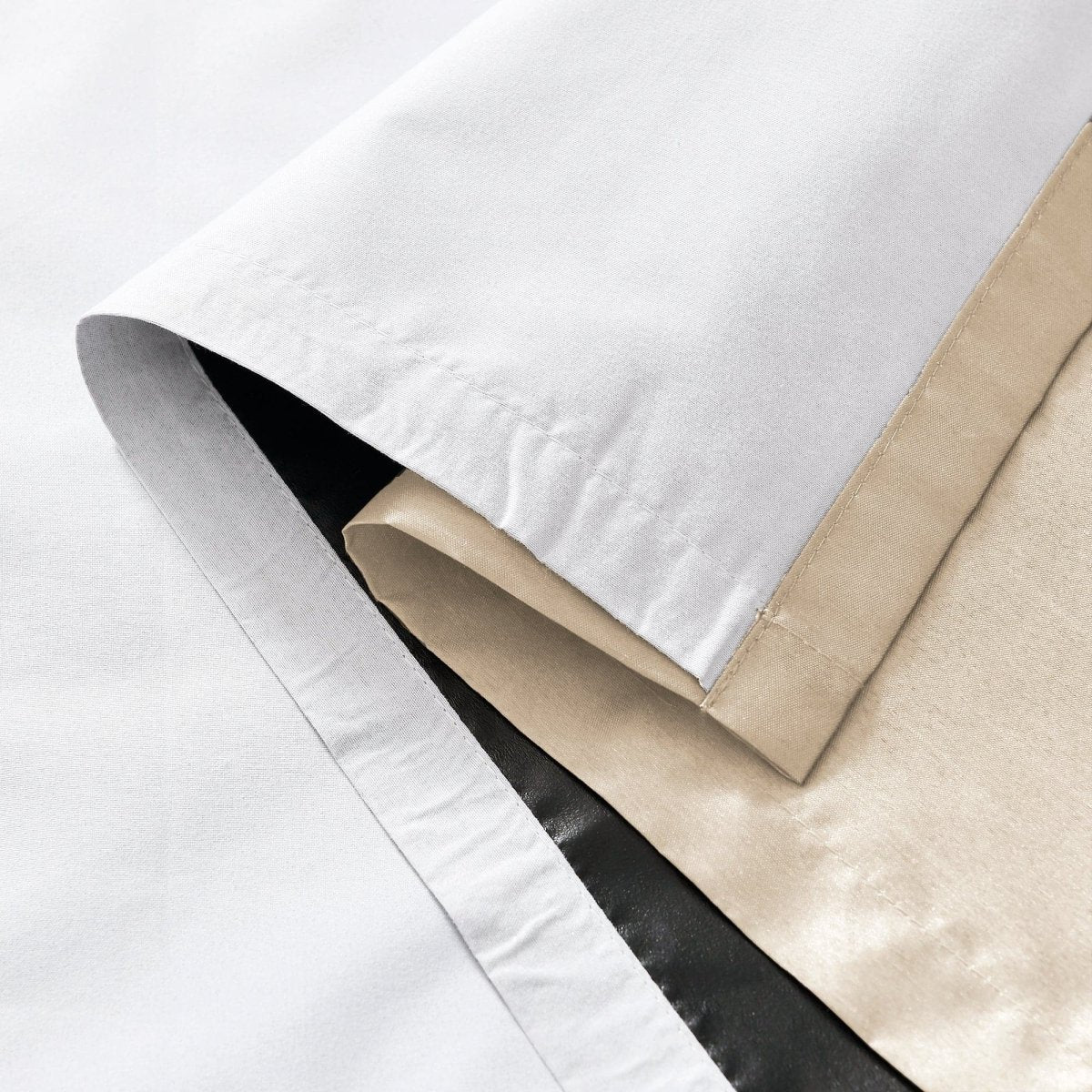 Close-up of the layers of a Faux Silk 100% Blackout Window Curtain showing smooth textures and colors.