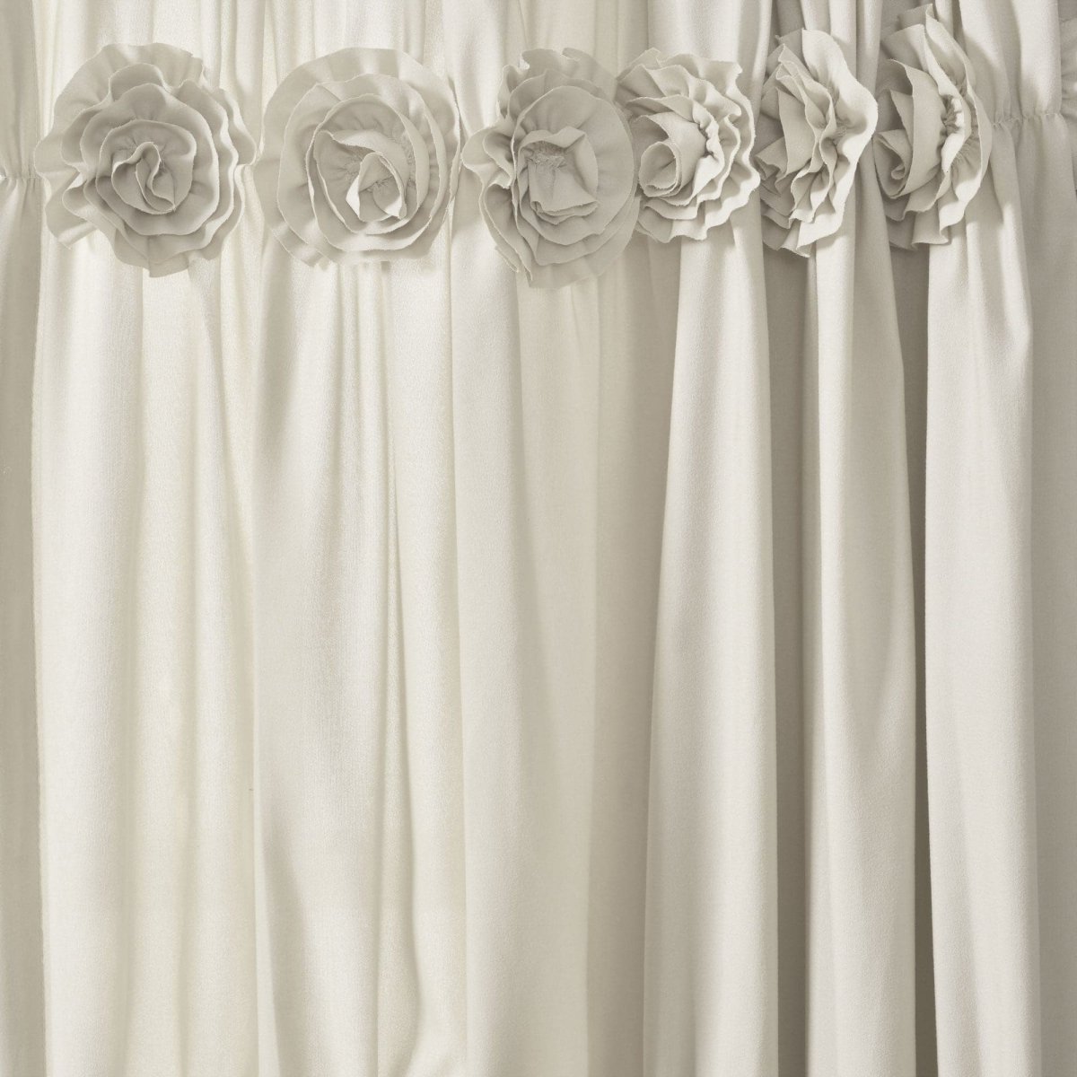 Darla Window Curtain featuring hand crafted flower embellishments in a cream color, adding a shabby chic look to windows.