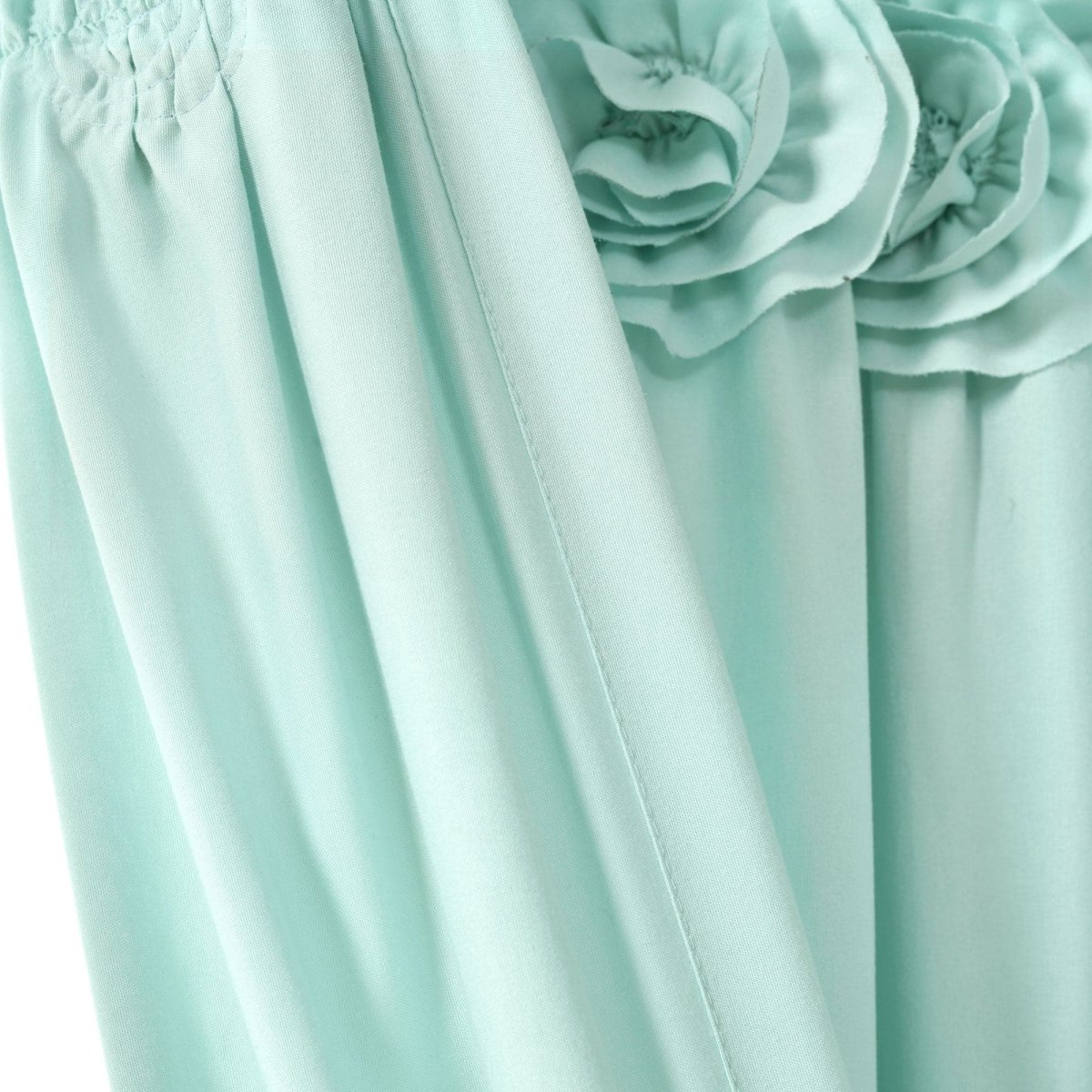 Close-up of the Darla Window Curtain highlighting handcrafted flower embellishments in a soft mint color.