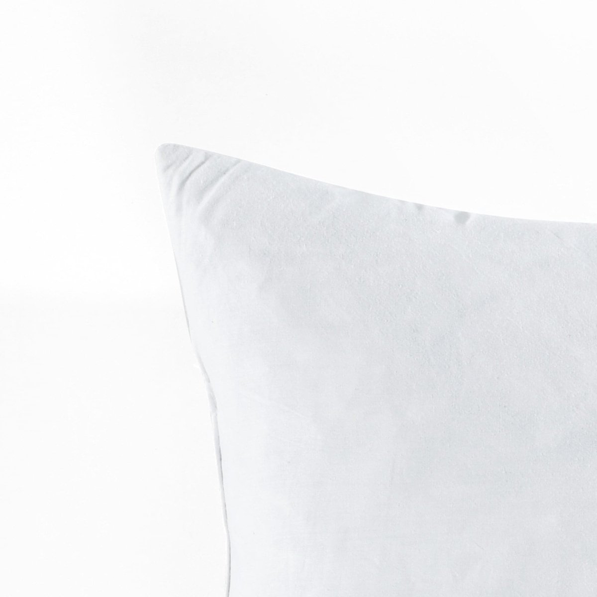 Feather Down in Cotton Decorative Pillow Insert corner with soft white fabric.