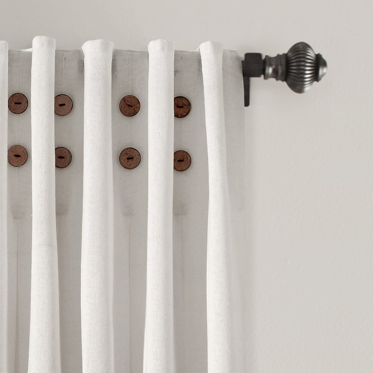 Linen Button Pinched Pleat Window Curtain panel with wooden buttons and elegant pleats hanging on a curtain rod.
