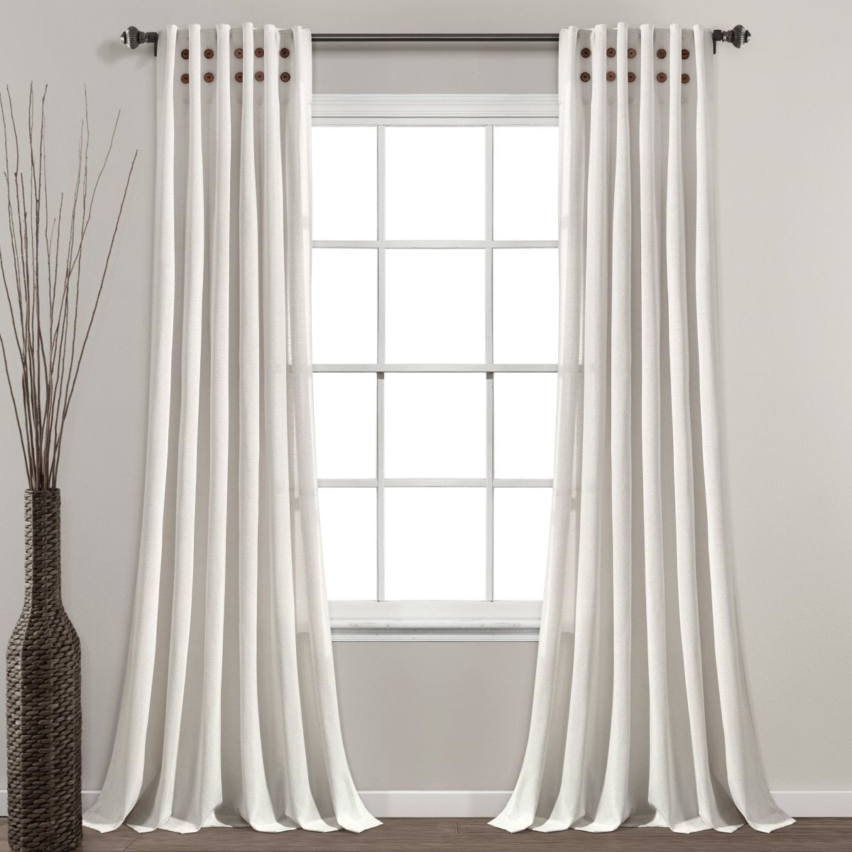 Linen Button Pinched Pleat Window Curtain hanging elegantly in a room with a modern vase.